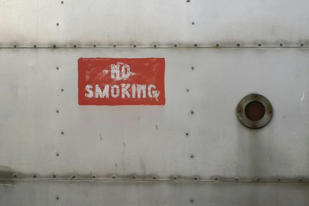 Weathered no smoking sign on a metal surface