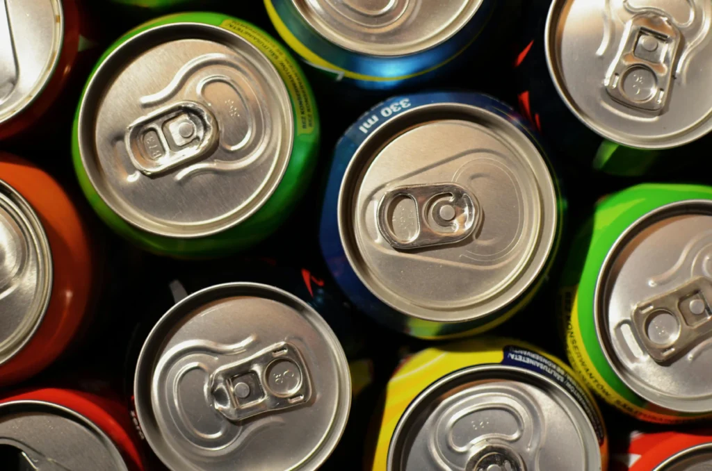 Close-up of colorful soda cans symbolizing sugary drink consumption