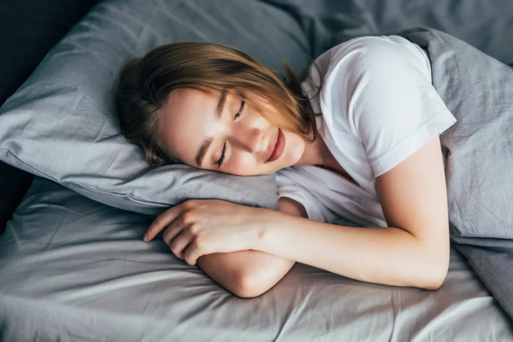 Young woman sleeping peacefully in bed – promoting healthy sleep for heart health