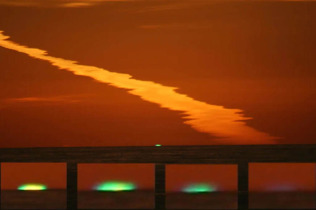 Green flash captured at sunset with inferior mirage over the ocean horizon