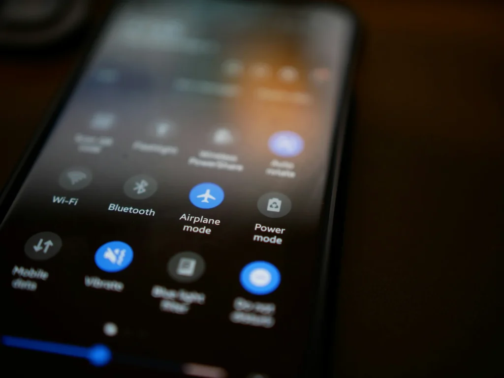 Smartphone screen showing quick settings like Airplane mode, Wi-Fi, and Power mode