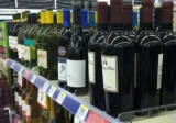 Wine placed under a “Water” sign. Funny labeling fail in a grocery store aisle.