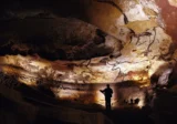 Lascaux Cave discovery showing prehistoric animal paintings illuminated inside the cave